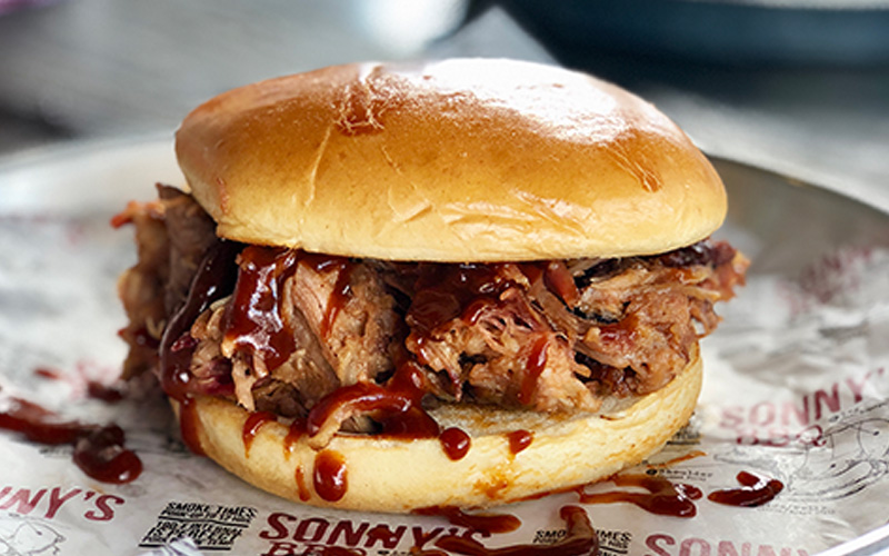 Pulled pork sandwich smothered in bbq sauce